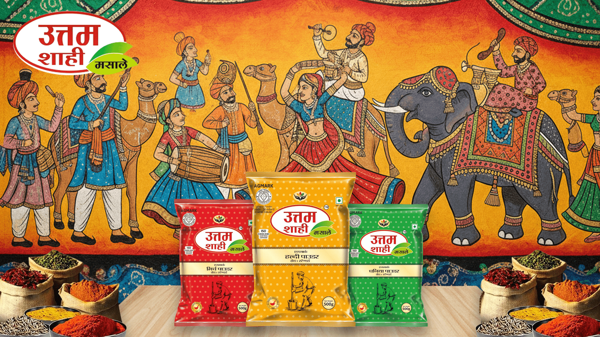 Packets of Uttam Shahi Red Chili Powder, Turmeric Powder, and Coriander Powder with traditional Rajasthani artwork background featuring elephants and dancers.